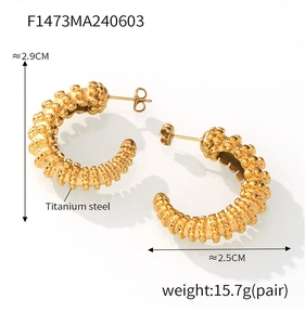 Detailed macro view of 18k gold plated titanium steel C-shape earrings with grainy texture