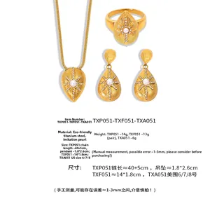 Detail view of gold titanium steel jewelry set with seashell textures and white pearls