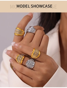 Detail of multi-layer gold and silver rings with pavé set crystals on a model's hand