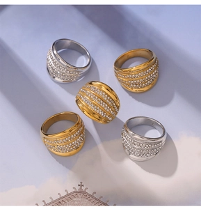 Detail of wide multi-row paved zircon rings in gold and silver finish with size engravings