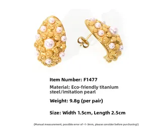 Detailed macro view of vintage gold plated steel earrings with shell pearls and relief