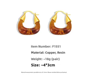 Detailed view of U-shaped amber resin earrings with vintage golden copper hardware