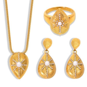 Luxurious gold starburst pearl jewelry set with teardrop necklace, ring and earrings