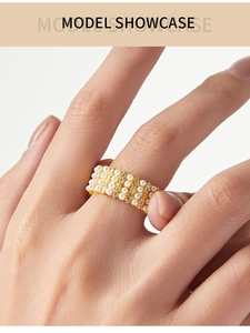 Macro detail of wide 18K gold plated ring with triple rows of pearls and accent diamonds