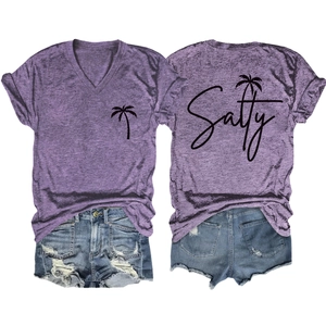 Detail of salty coconut tree print on purple V-neck T-shirt with distressed denim shorts