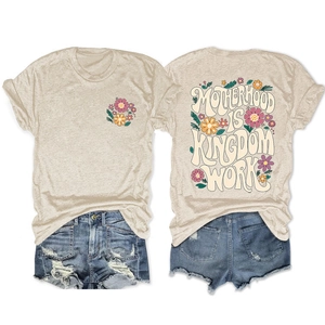 Front and back view of t-shirt with Motherhood Is Kingdom Work text and floral embroidery