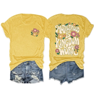 Detail of floral print and Motherhood Is Kingdom text on yellow T-shirt and denim shorts