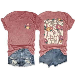 Flat lay of pink Motherhood is Kingdom t-shirt with distressed denim shorts detail