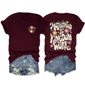 Detail of burgundy T-shirt showing vintage floral print and Motherhood Is Kingdom text