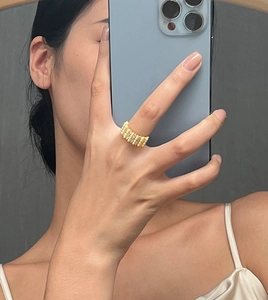 Mirror selfie showing 18K gold plated pearl ring on finger with geometric vintage design