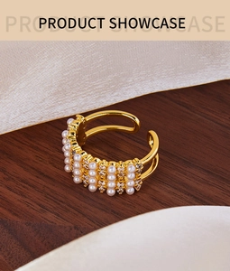 Detail of 18K gold plated wide ring with rows of white pearls and sparkling zircons