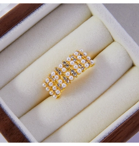 Macro shot of 18K gold plated ring with geometric pearls and sparkling zircons