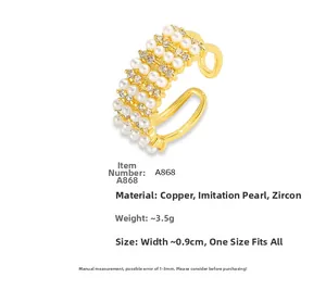 Detail of 18K gold plated ring with four rows of pearls and cubic zirconia stones