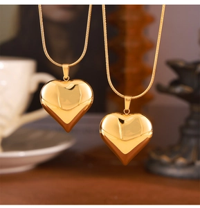Detail of 3D gold heart pendant on a snake chain with a high-polish mirror finish
