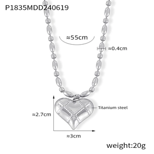 Detailed view of quilted texture heart pendant on 55cm silver titanium steel bead chain