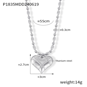 Macro view of titanium steel heart pendant with grid texture and oval bead chain details