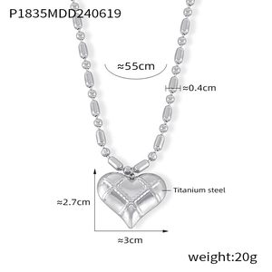 Detailed view of silver heart pendant with quilted texture on titanium steel bead chain