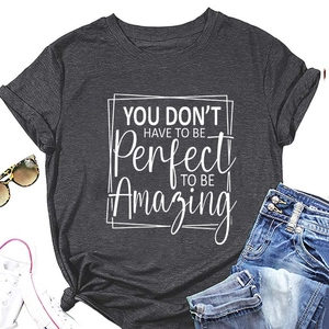 Flat lay of dark grey T-shirt with 'YOU DON'T HAVE TO' print and casual accessories