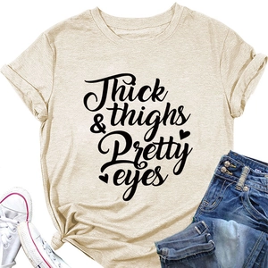 Detail of beige cotton T-shirt featuring Thick & Thighs slogan print and knotted hem