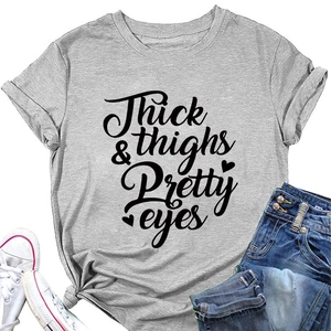 Flat lay of gray crewneck T-shirt with Thick & Thighs print, denim shorts and sneakers