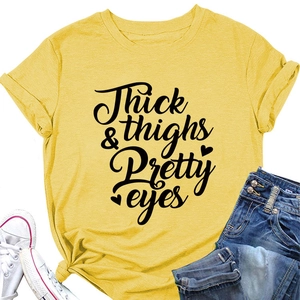 Detail of yellow cotton T-shirt featuring Thick Thighs & Pretty Eyes text print
