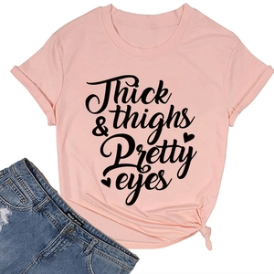 Detailed view of pink cotton T-shirt featuring black Thick Thighs Pretty Eyes lettering