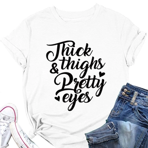 Close-up of Thick Thighs & Pretty Eyes lettering on a white cotton crewneck t-shirt