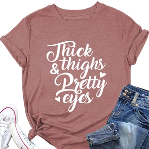 Detail of pink cotton T-shirt featuring Thick & Thighs Pretty Eyes lettering with knot hem