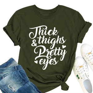 Close-up of olive green t-shirt with Thick Thighs & Pretty Eyes print and blue jeans