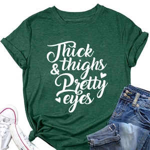 Close-up of dark green t-shirt featuring Thick & Thighs Pretty Eyes print and heart