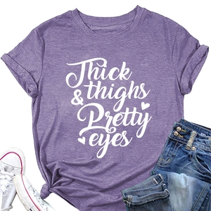 Close-up of purple t-shirt with Thick Thighs & Pretty Eyes print and side knot detail
