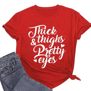 Detail of red crewneck T-shirt with white Thick & Thighs Pretty Eyes lettering
