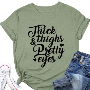 Flat lay of sage green T-shirt with Thick & Thighs slogan, jeans and white sneakers