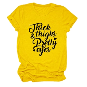 Detailed view of yellow cotton t-shirt with Thick Thighs Pretty Eyes lettering print