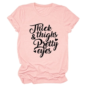 Close-up of pink crew neck T-shirt with black Thick & Thighs Pretty Eyes lettering