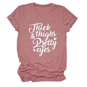 Close-up of crew neck t-shirt with Thick & Thighs Pretty Eyes print in dusty rose