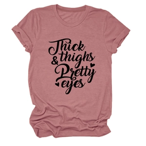 Detail of pink cotton T-shirt featuring black 'Thick thighs Pretty eyes' script print