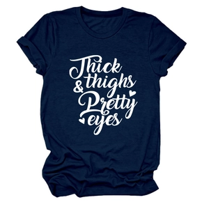 Detail of Thick Thighs Pretty Eyes script print on a navy blue cotton crewneck T-shirt