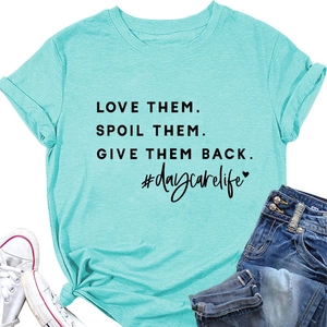 Flat lay of mint green cotton t-shirt with Love Them slogan and denim jeans