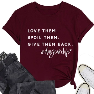 Flat lay of wine red crew neck t-shirt with daycare life slogan and denim jeans