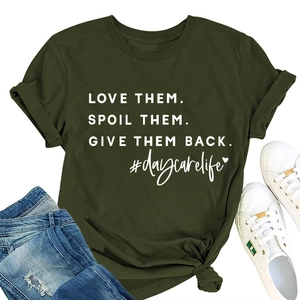 Flat lay of olive green crew neck tee with white typography and denim jeans