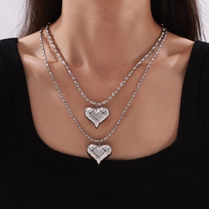 Double-layered stainless steel necklace with quilted heart pendants on beaded chain