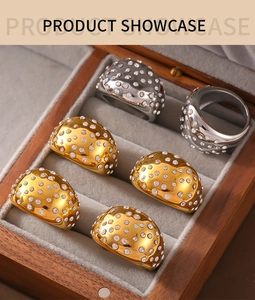 Detailed view of gold and silver thick geometric rings with pavé rhinestones in a jewelry box