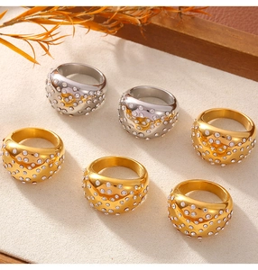 Detail of wide geometric 18k gold and silver rings with pave set rhinestones