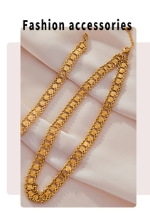 Detail of warm gold multilayer chain with geometric starburst square plates and lobster clasp
