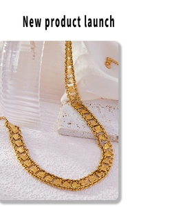 Macro detail of gold plated layered necklace with sunburst embossed square plates