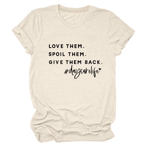 Detail of cream crew neck T-shirt with LOVE THEM SPOIL THEM slogan and cuffed sleeves
