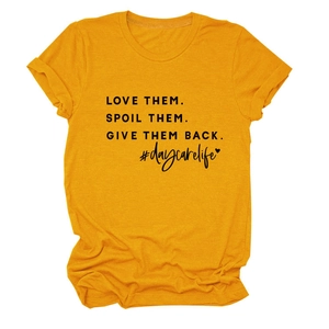 Detail of Mustard Yellow T-shirt with LOVE THEM SPOIL THEM slogan print and soft cotton texture