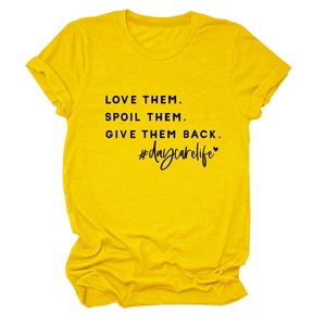 Detail of yellow round neck T-shirt featuring LOVE THEM SPOIL THEM black printed text