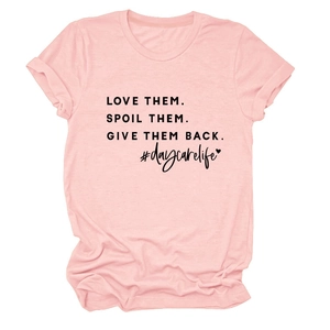 Detailed view of pink cotton T-shirt featuring bold black graphic slogan and text